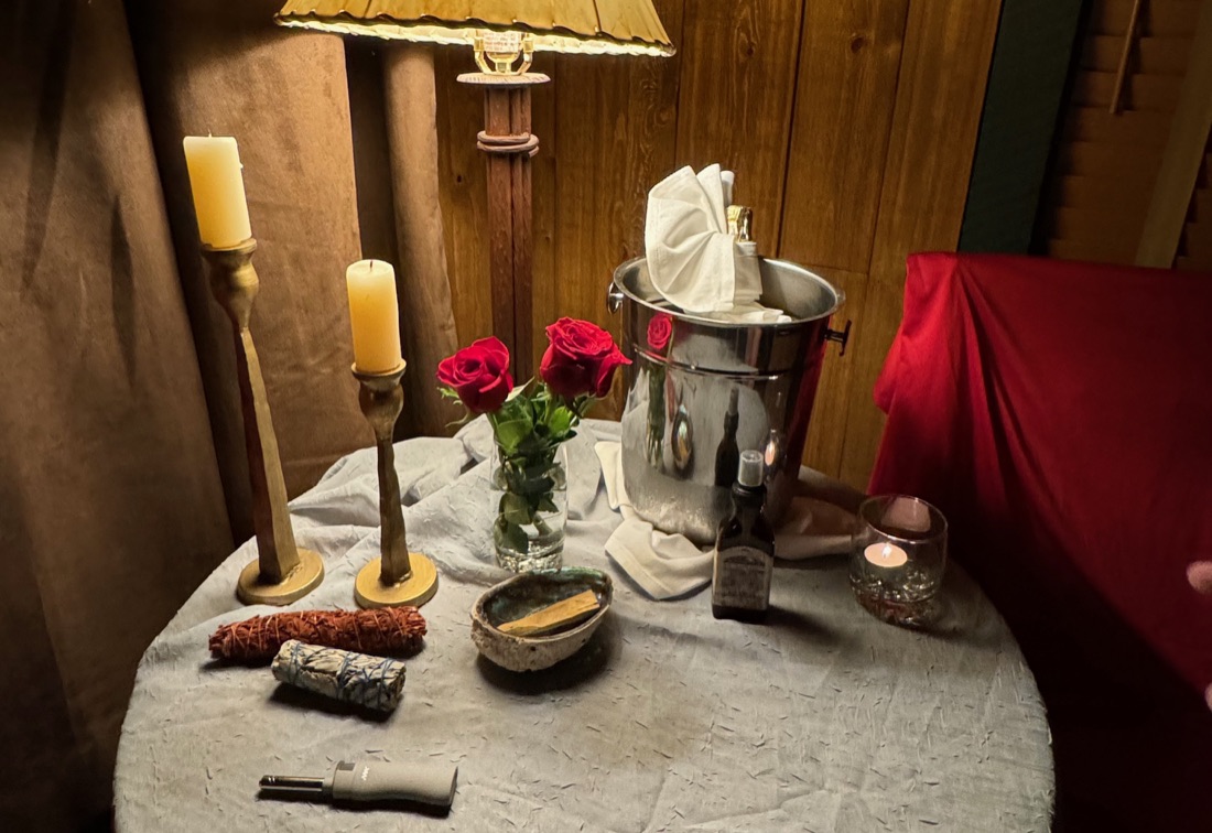 A candlelit table set with roses